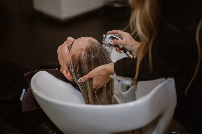 Hairstylist preparing a polished hairstyle for finishing hairspray