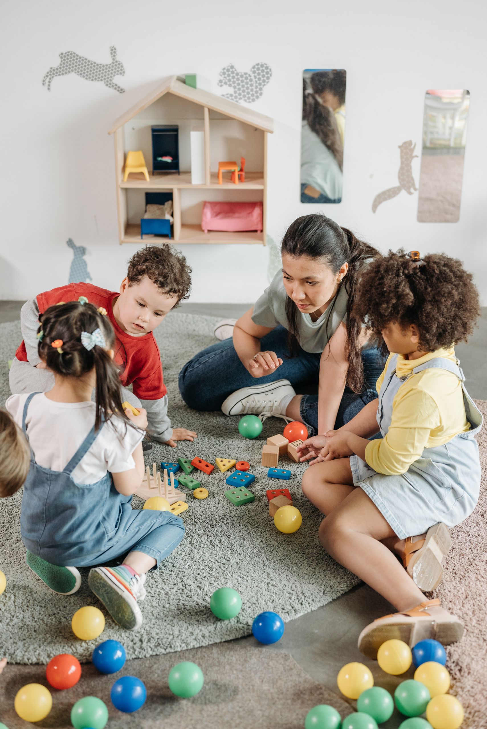 Teacher and children using educational toys in a preschool classroom
